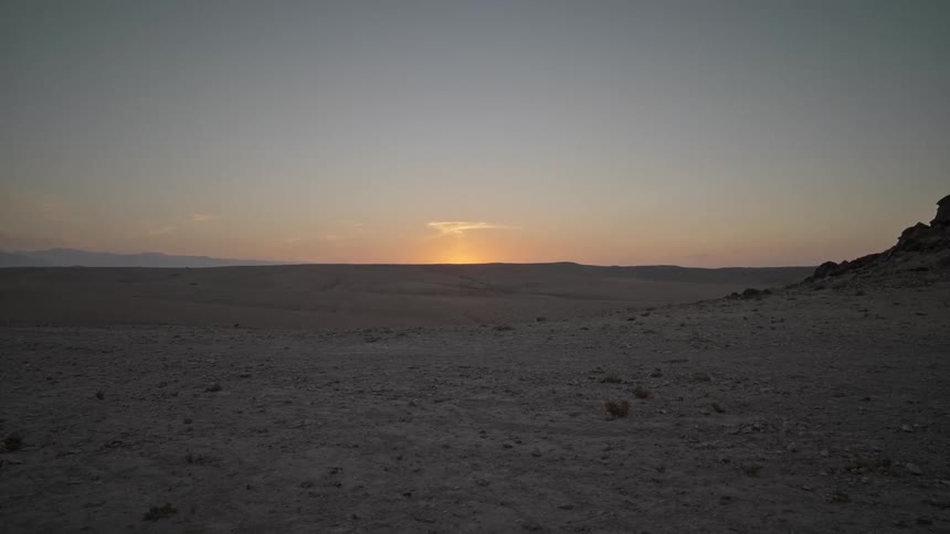 Sun is low in the horizon as it sets above the landscape