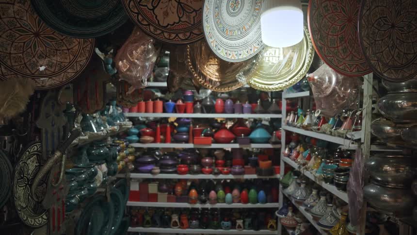 A store filled with colorful pottery on shelves