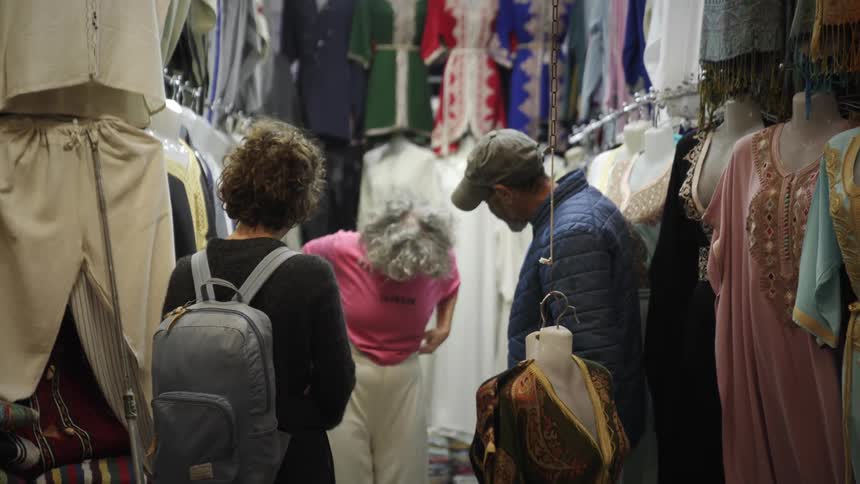 Woman shopping for clothes on an open market