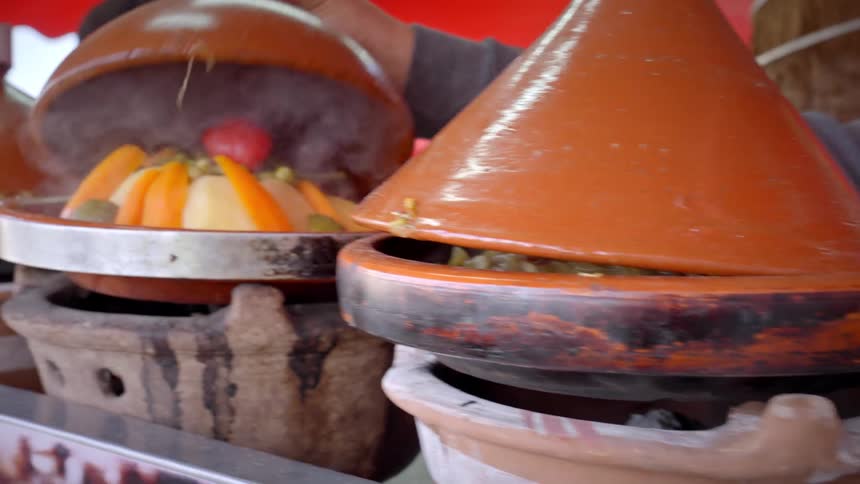 A man shows off food cooking