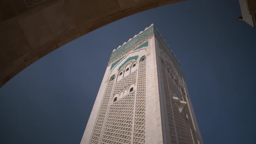 Upward view of a sprawling temple tower on a cloudless blue sky day