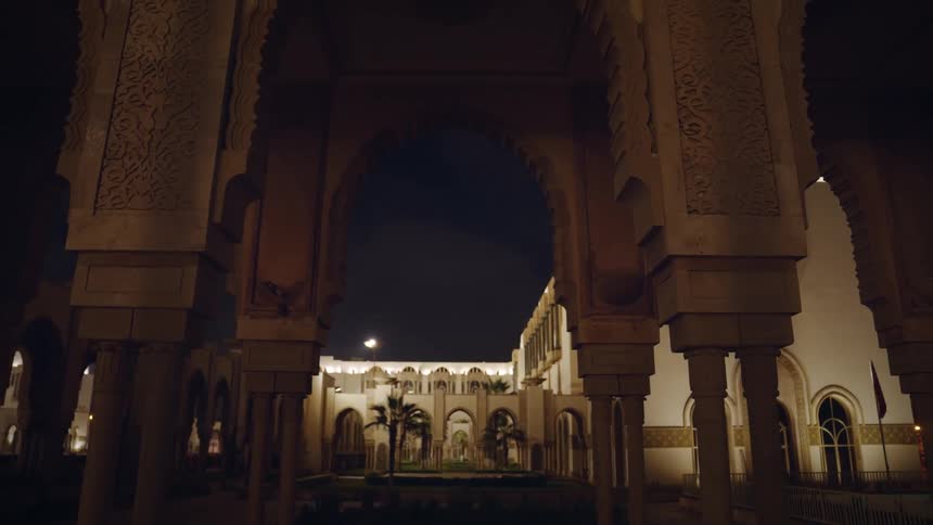 An arched structure sits in front of another building