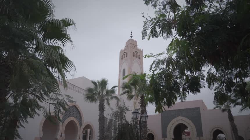 Arabic religious temple with a large tower on a cloudy day