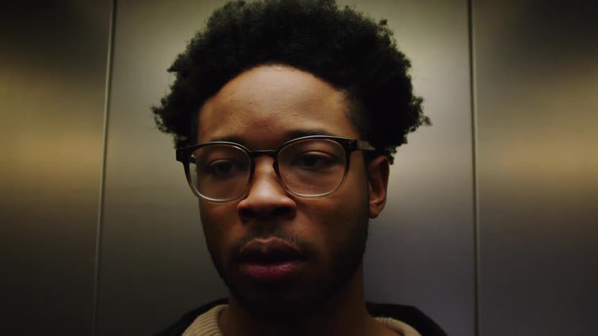Man is waiting in an elevator and then walks out