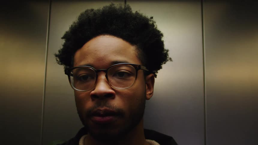 Man waiting in an elevator and exits through the door