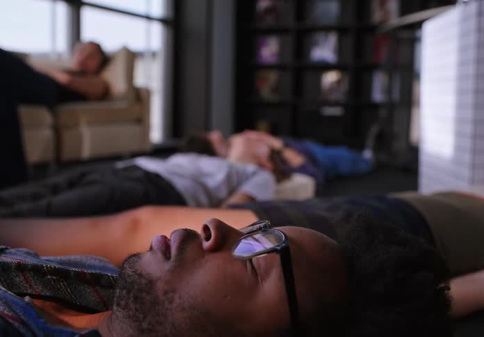 A group of office workers taking a nap
