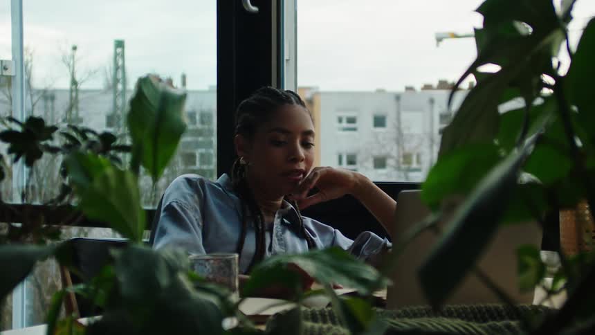 A clip of a lady studying beside the window