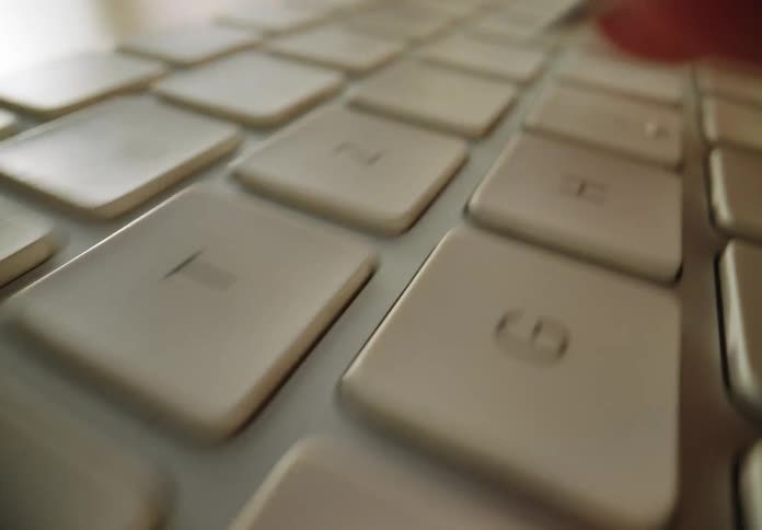 A person is typing on the keyboard
