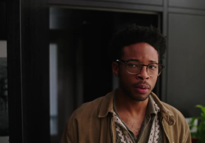 A man opens a door and walks into an office