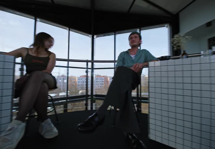 A group of people sitting in a small circular room