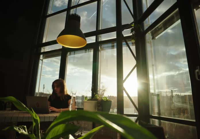 Woman working in the office at dusk