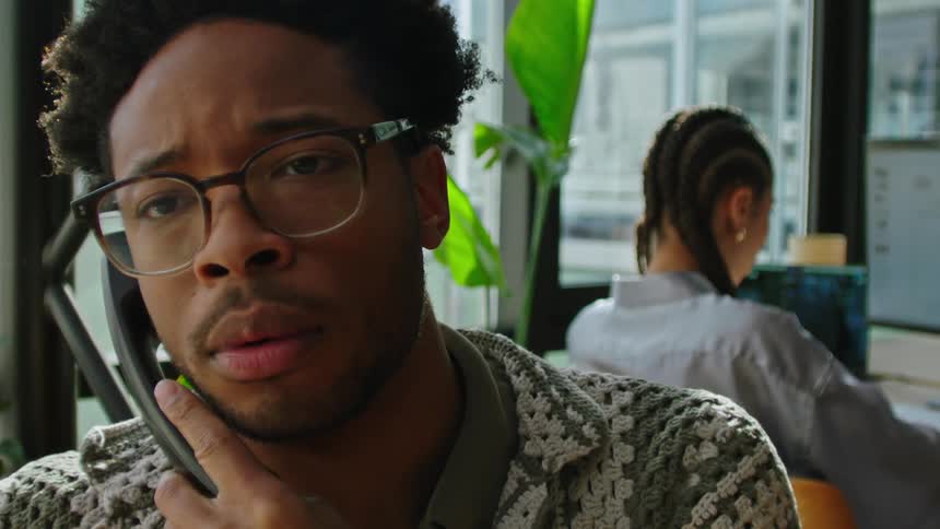 A man talking on the phone is sad and shocked