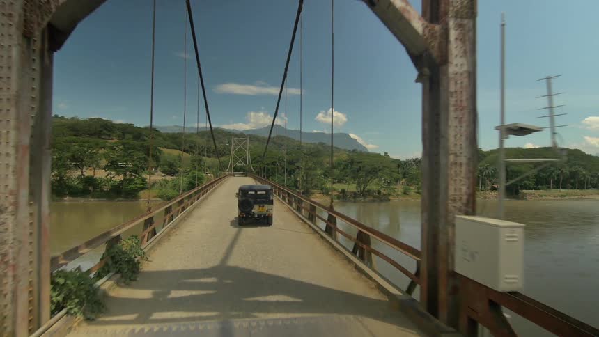 A person driving over a bridge