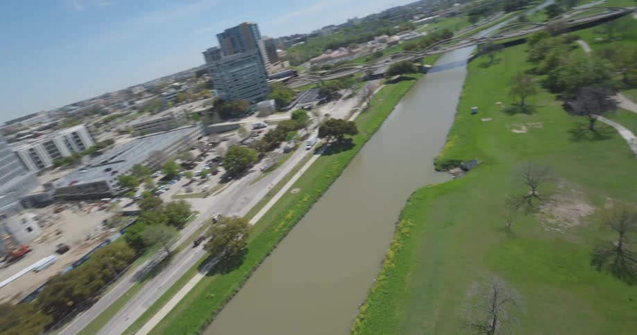 Aerial panorama of a metropolitan city with a skyscraper and the edge of a river canal