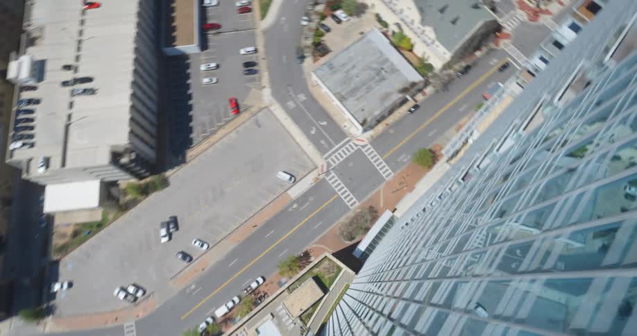 Quickly moving down a tall building over a city