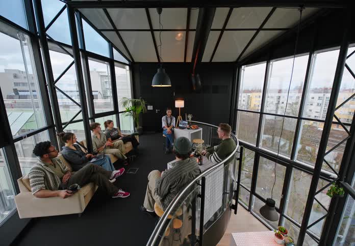 A group of office workers enjoy a break in the lounge