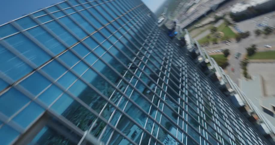 A clip of a glass skyscraper in a community