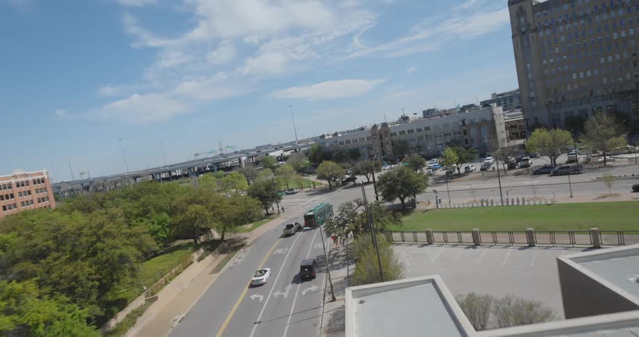 Aerial view of vehicles on a city street under a blue sky
