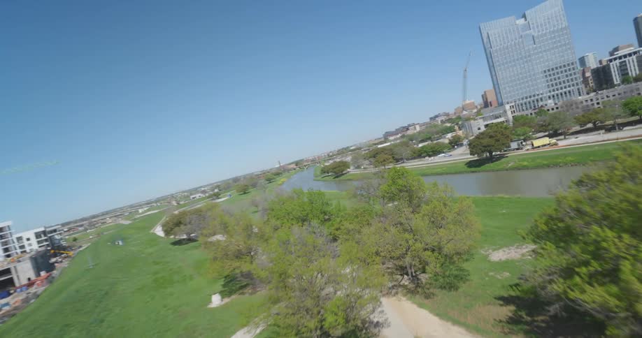 Aerial view of a river on a park in the city under a blue sky
