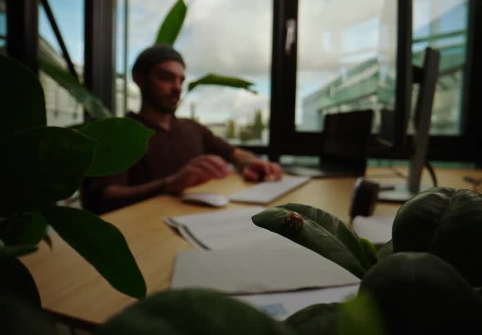 Man is typing on a computer indoors