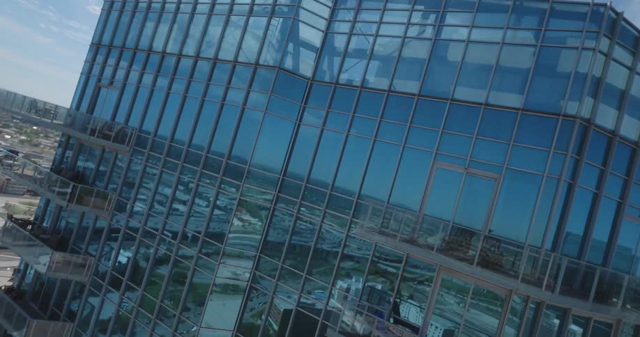 Drone footage flying around a modern building in the city