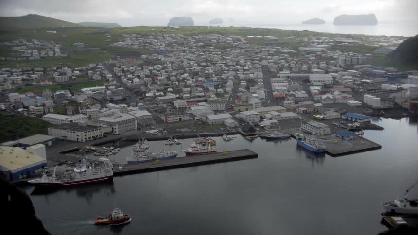 Aerial panorama of an urban city on the edge of a sea canal in a natural environment