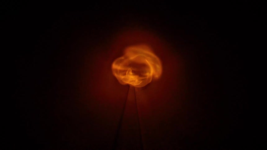 A clip of fire traveling through a small hole