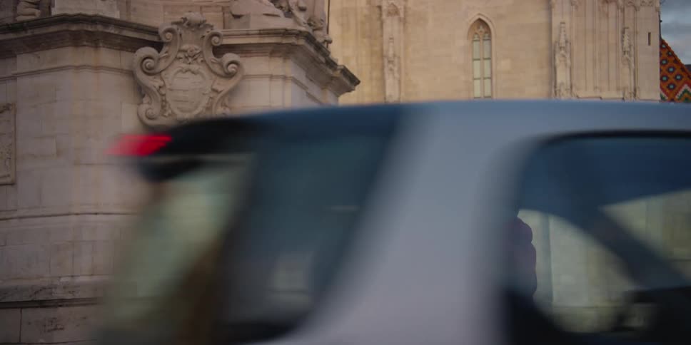 Two people talking near Matthias Church in Holy Trinity Square Budapest Hungary