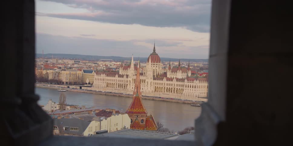 Traffic drives along Danube River highway near Hungarian Parliament Building in Budapest