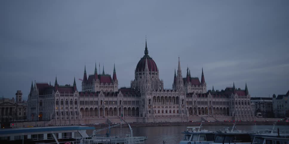 Panorama of Hungarian Parliament building across the Danube River in Budapest at dusk