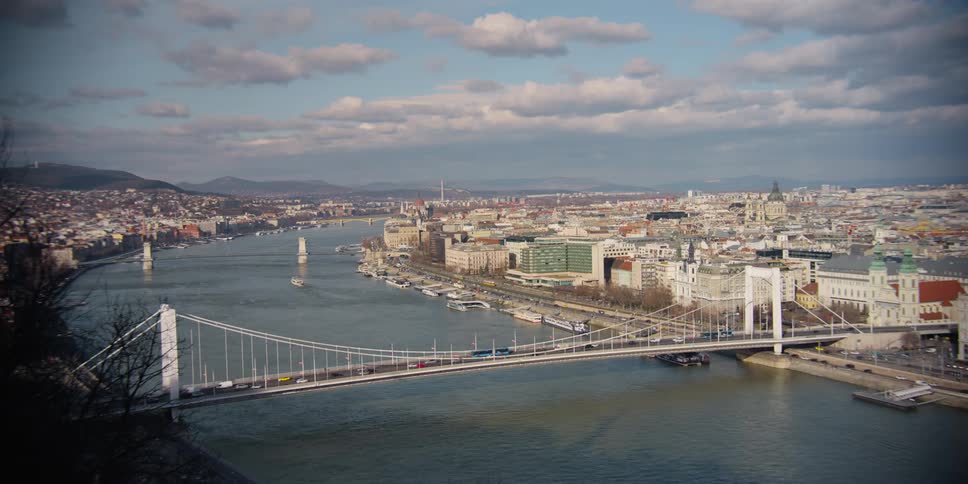 The Elizabeth bridge passing over the Danube River connecting Budapest that is passing many cars