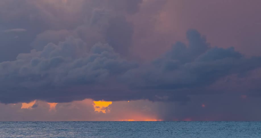 Time lapse of clouds moving over a calm ocean