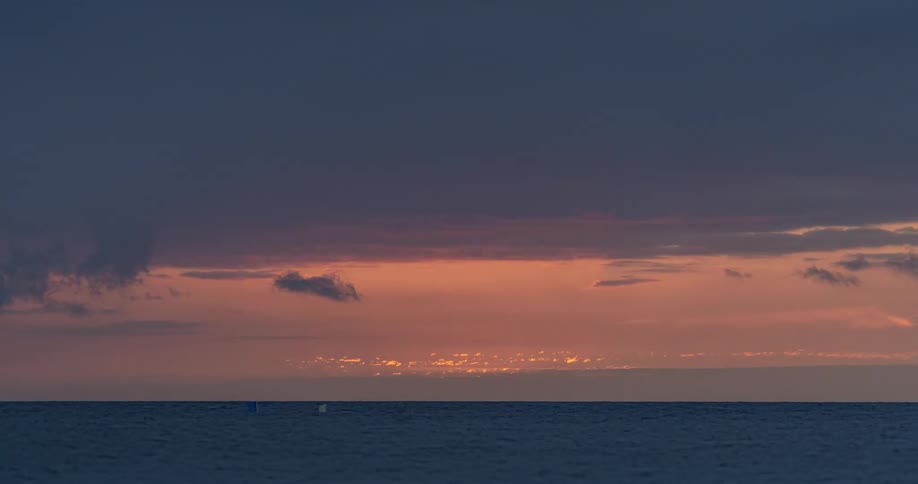 Time lapse of the sun setting over the ocean