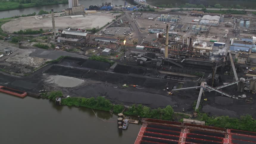 An aerial view of an oil refinery next to a river