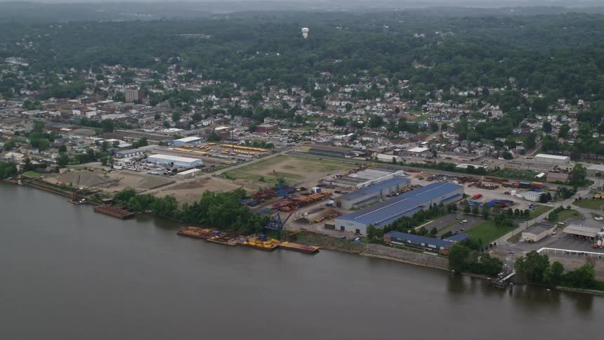 Warehouses by a river near a suburban town