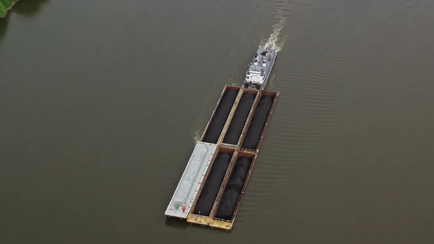 Aerial panorama of a cargo boat crossing a river channel