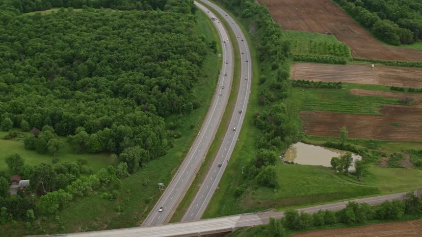 Aerial panorama of a twoway highway in the middle of forested hills