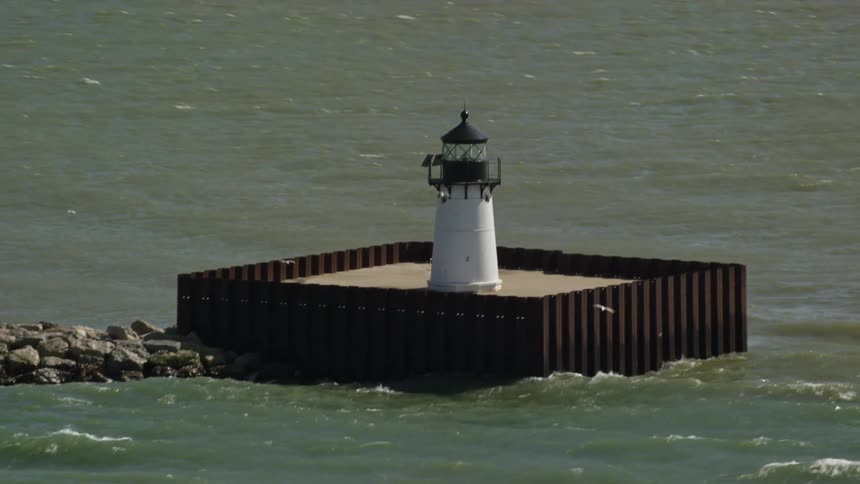 Birds fly around the light house