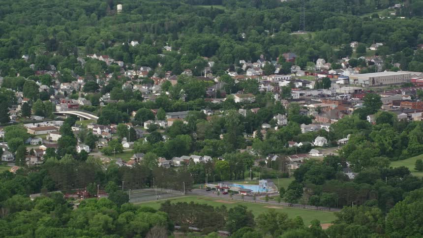 Aerial panorama of an urban city in an area of hills and vegetation