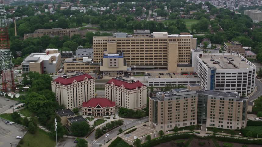 Aerial panorama of commercial and residential buildings surrounding neighborhoods with houses on hills