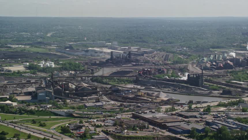 An aerial view of an industrial area with large factory buildings and smokestacks