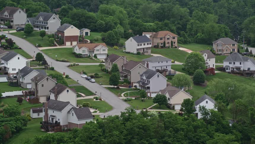 Aerial of a quaint seculded residential neighborhood surrounded by trees
