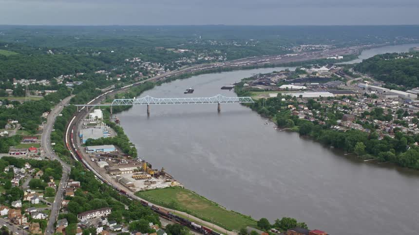 Aerial view of a river canal dividing urban cities and interconnected by a bridge