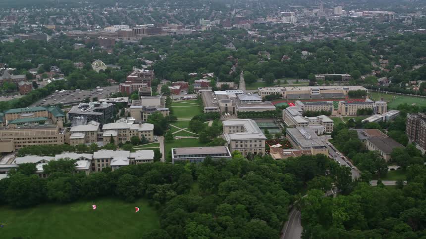 Aerial panorama of an urban city with public commercial and sports buildings during the day
