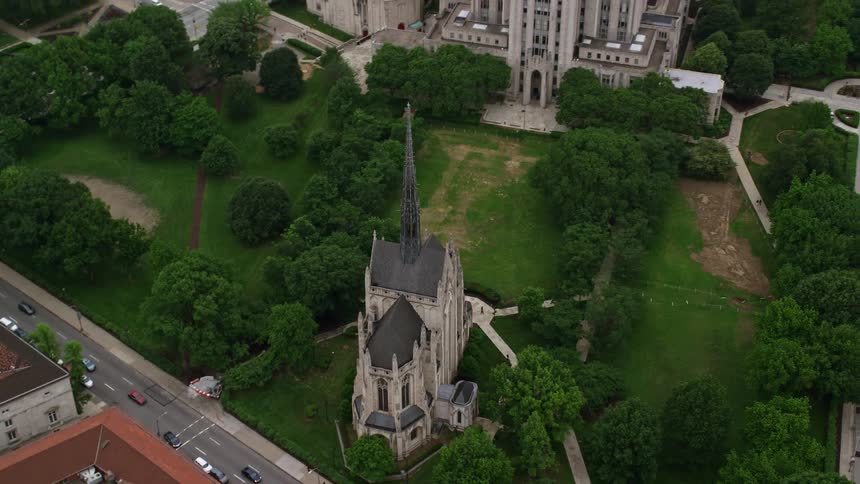 Traffic moves past an old church in a city