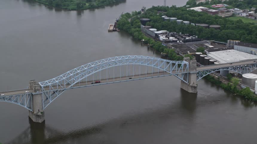 Traffic drives across a bridge over a river