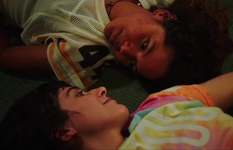 Close up of two teenage girls laughing on the floor