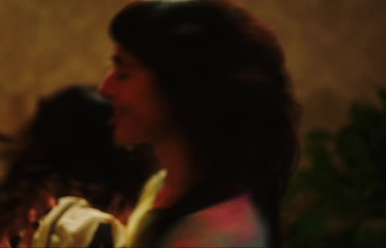 Two young adult girls dancing and laughing having a good time indoors