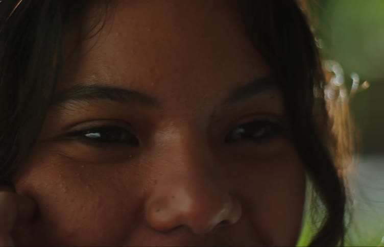 Close up of the face of a happy teenager smiling outdoors