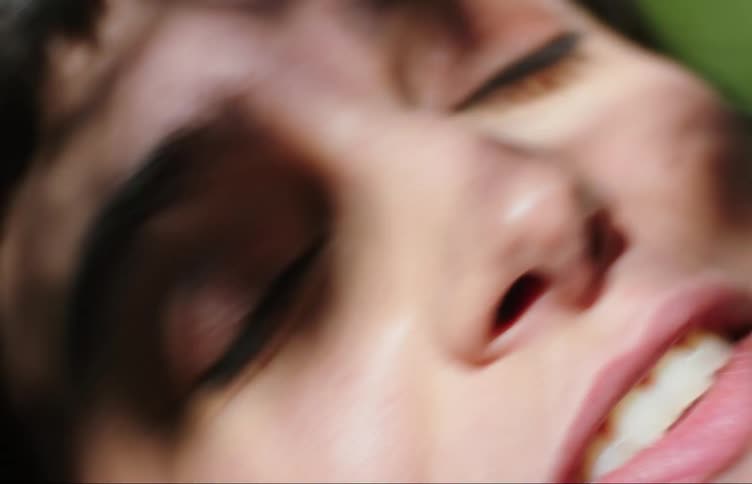 A woman smiles outside